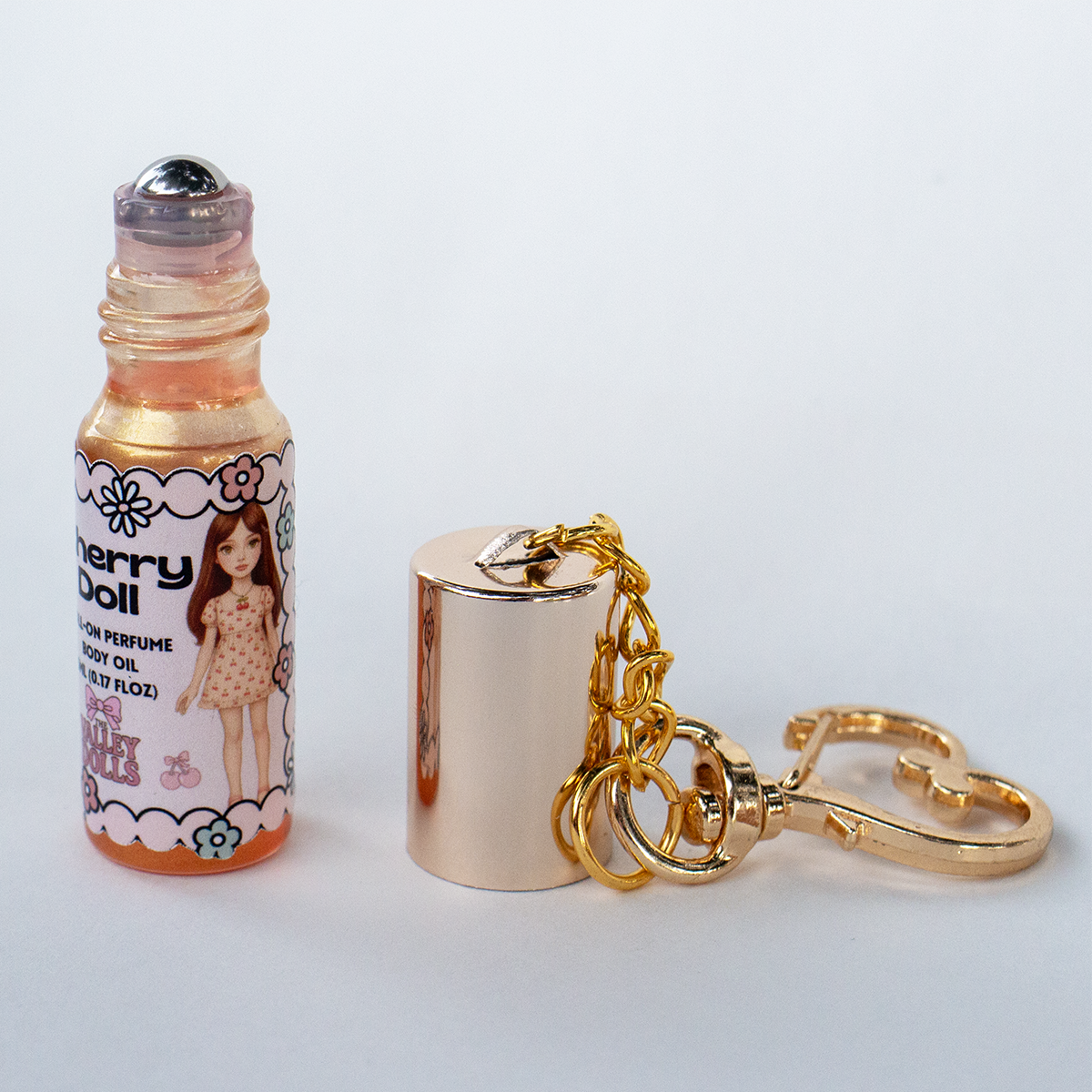 Cherry Doll perfume oil roll-on, 5 ml glass bottle with rollerball applicator and gold heart keychain clasp – juicy cherry scent by The Valley Dolls