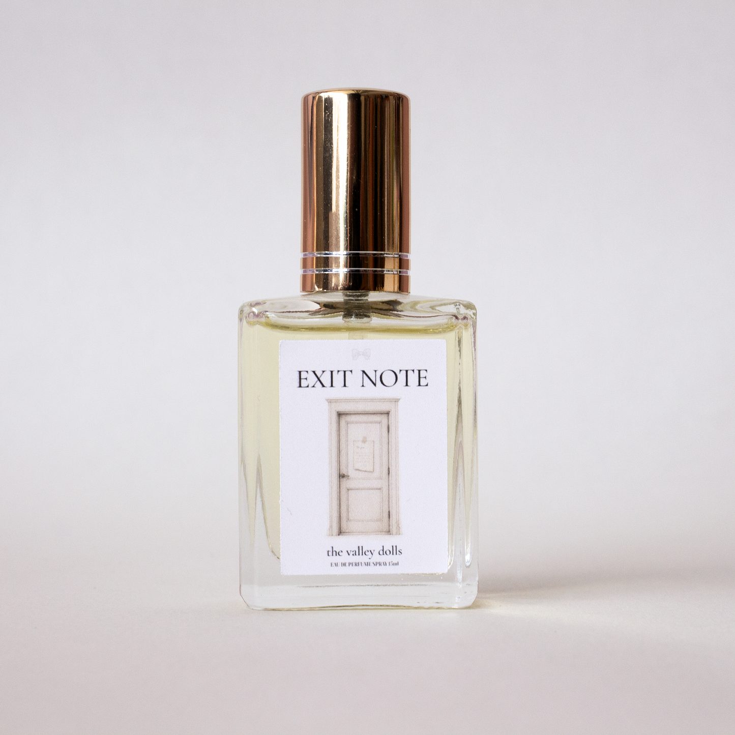 Luxury perfume bottle labeled “Exit Note” with gold cap on a white background