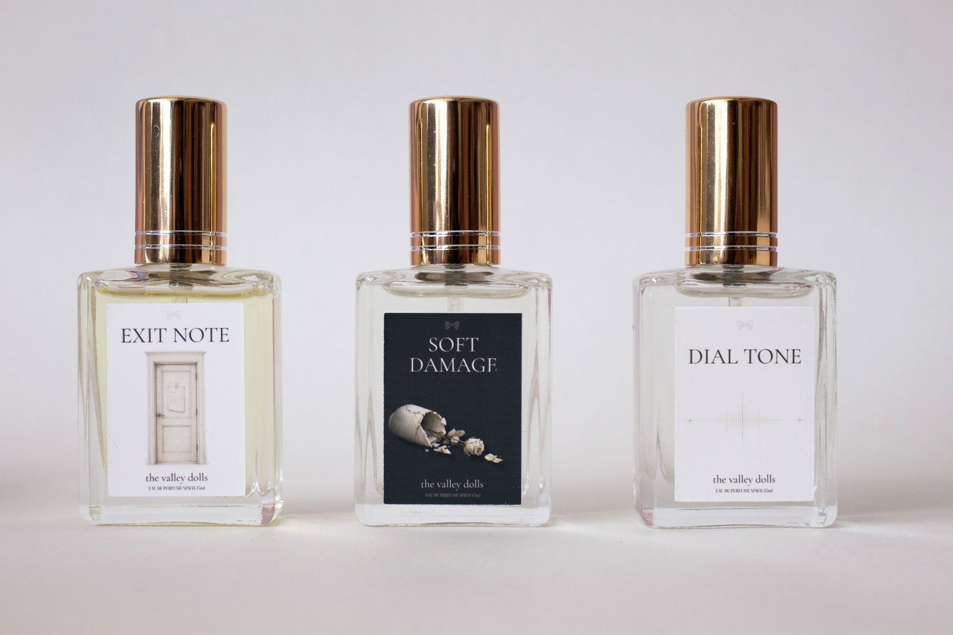 Three luxury perfume bottles from The Valley Dolls Linger Collection on a white background