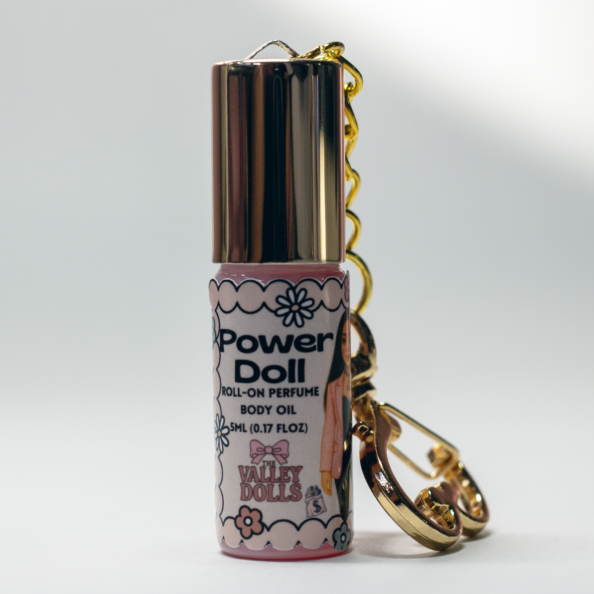 Power Doll perfume oil roll-on, gold heart keychain clasp detail on 5 ml glass bottle – portable fragrance from The Valley Dolls