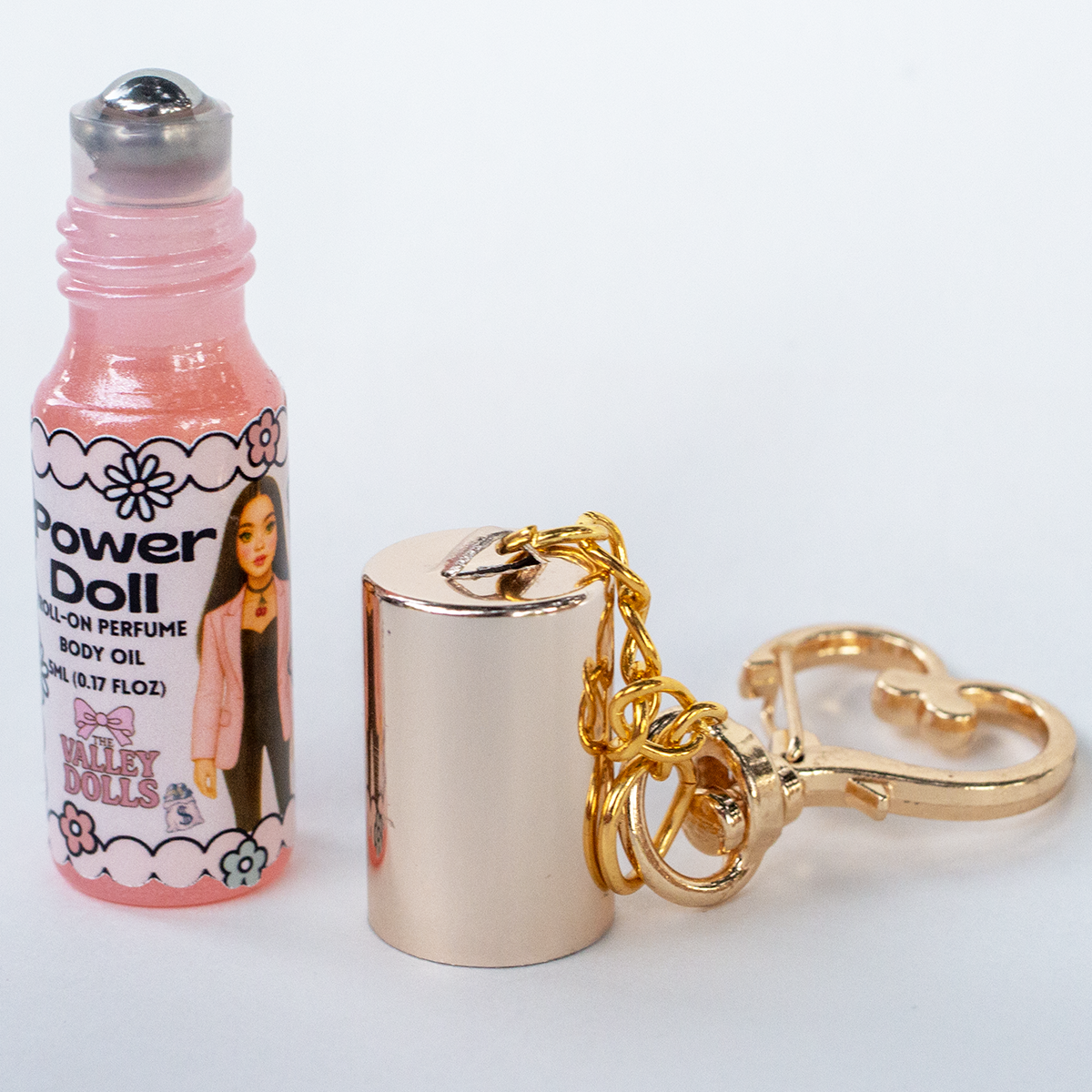 Power Doll perfume oil roll-on, 5 ml glass bottle with rollerball applicator and gold heart keychain clasp – The Valley Dolls fragrance collection