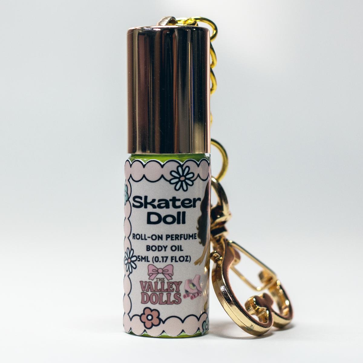 Noir Doll perfume oil roll-on, 5 ml glass bottle with rollerball applicator and gold heart keychain clasp – smoky sweet fragrance from The Valley Dolls
