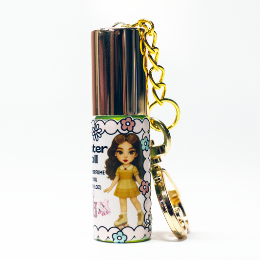 Noir Doll perfume oil roll-on, 5 ml glass bottle with rollerball applicator and gold heart keychain clasp – smoky sweet fragrance from The Valley Dolls