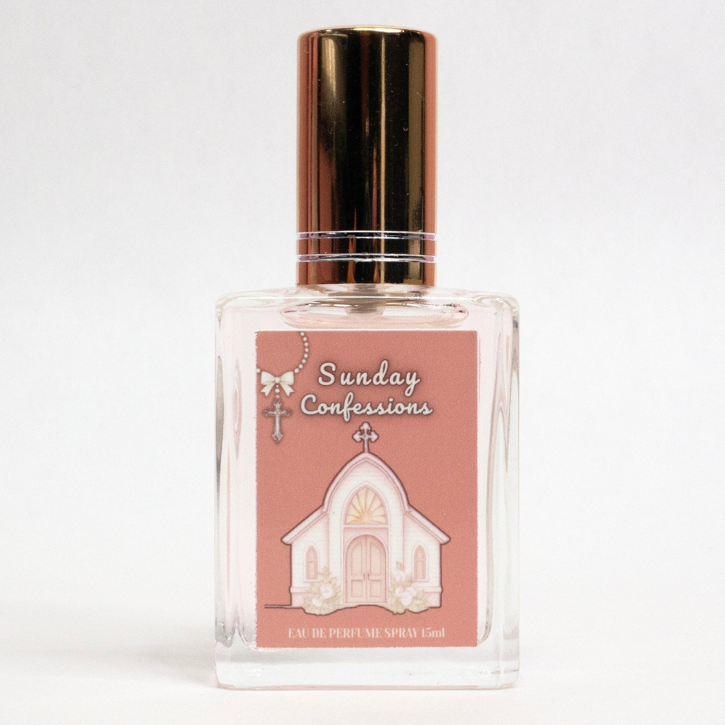 Valley Dolls Sunday Confessions limited edition perfume spray shown in a clear glass bottle with a church illustration label, photographed on a white background.