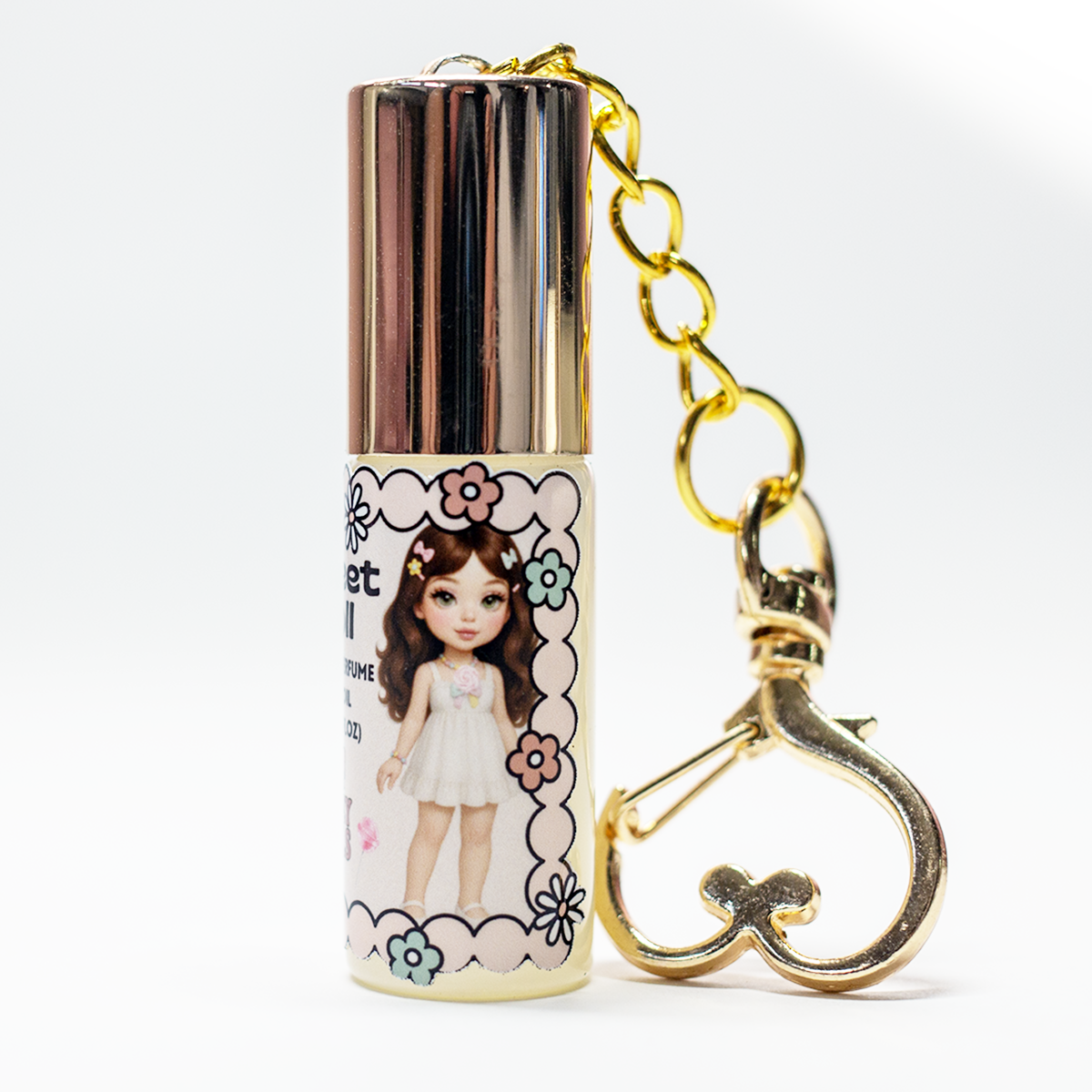 Sweet Doll perfume oil roll-on, gold heart keychain clasp detail on 5 ml glass bottle – The Valley Dolls fragrance collection