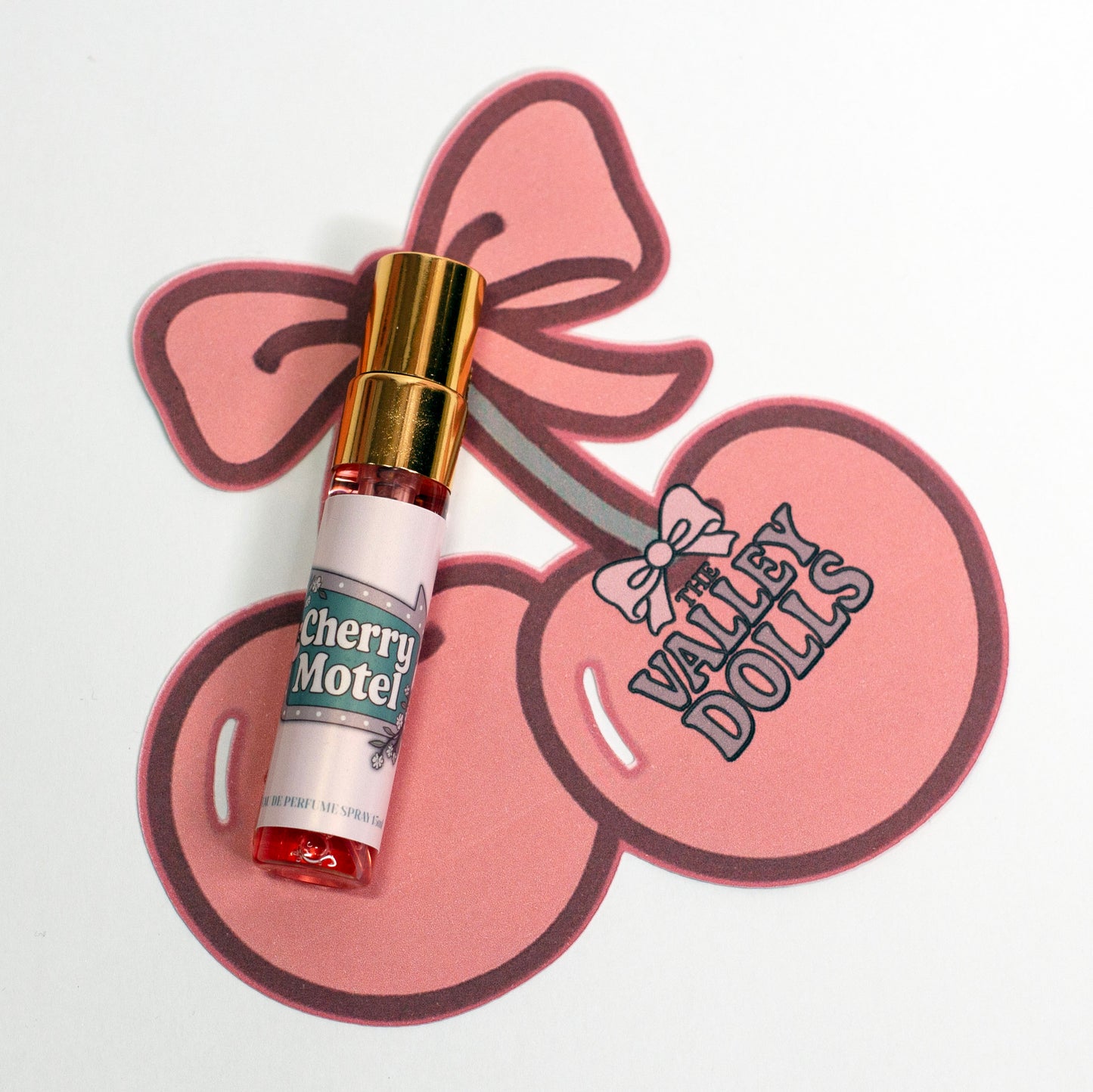Valley Dolls Cherry Motel 5 mL perfume spray sample presented on a decorative cherry-shaped backing card