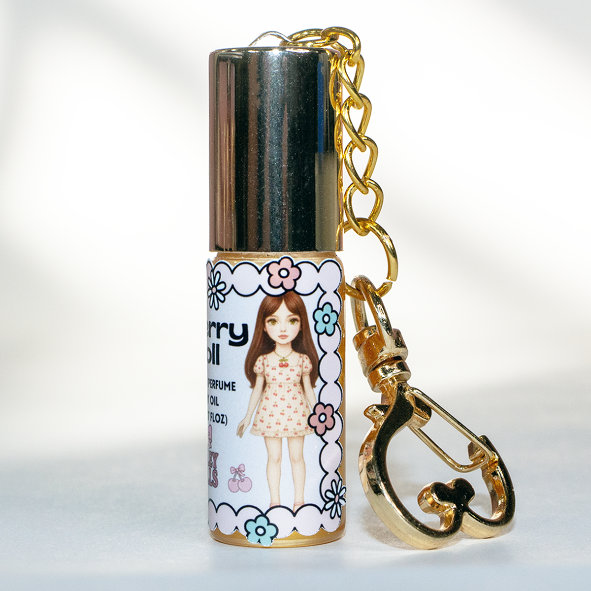 Cherry Doll cherry perfume oil roll-on, 5 ml glass bottle with gold heart keychain clasp – sweet fruity fragrance from The Valley Dolls