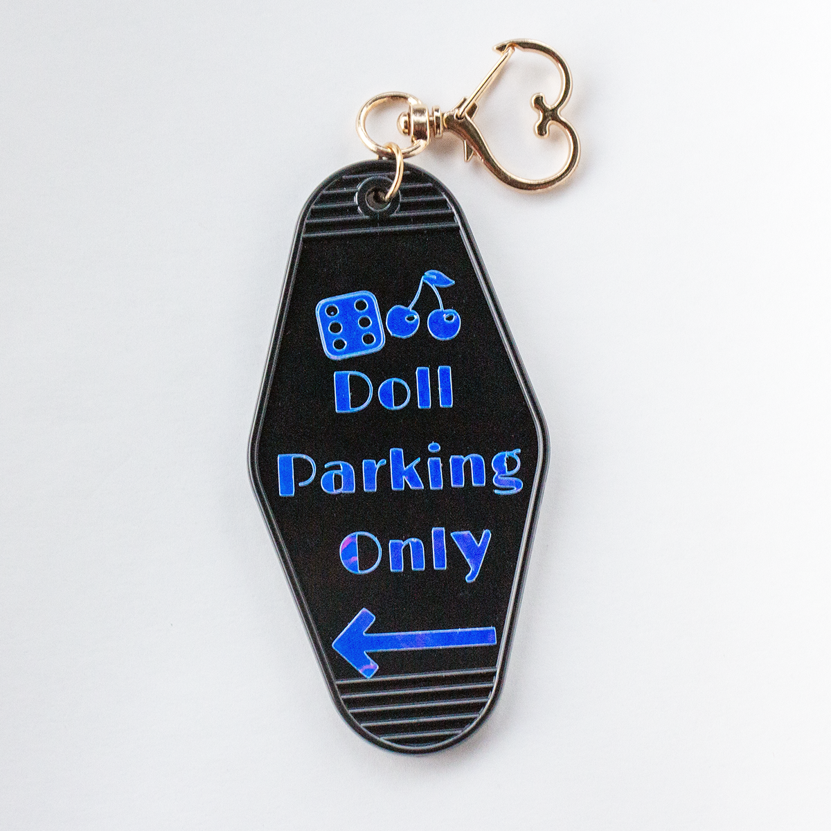 The Valley Dolls Doll Parking Only black acrylic motel keychain with cherry and dice icons