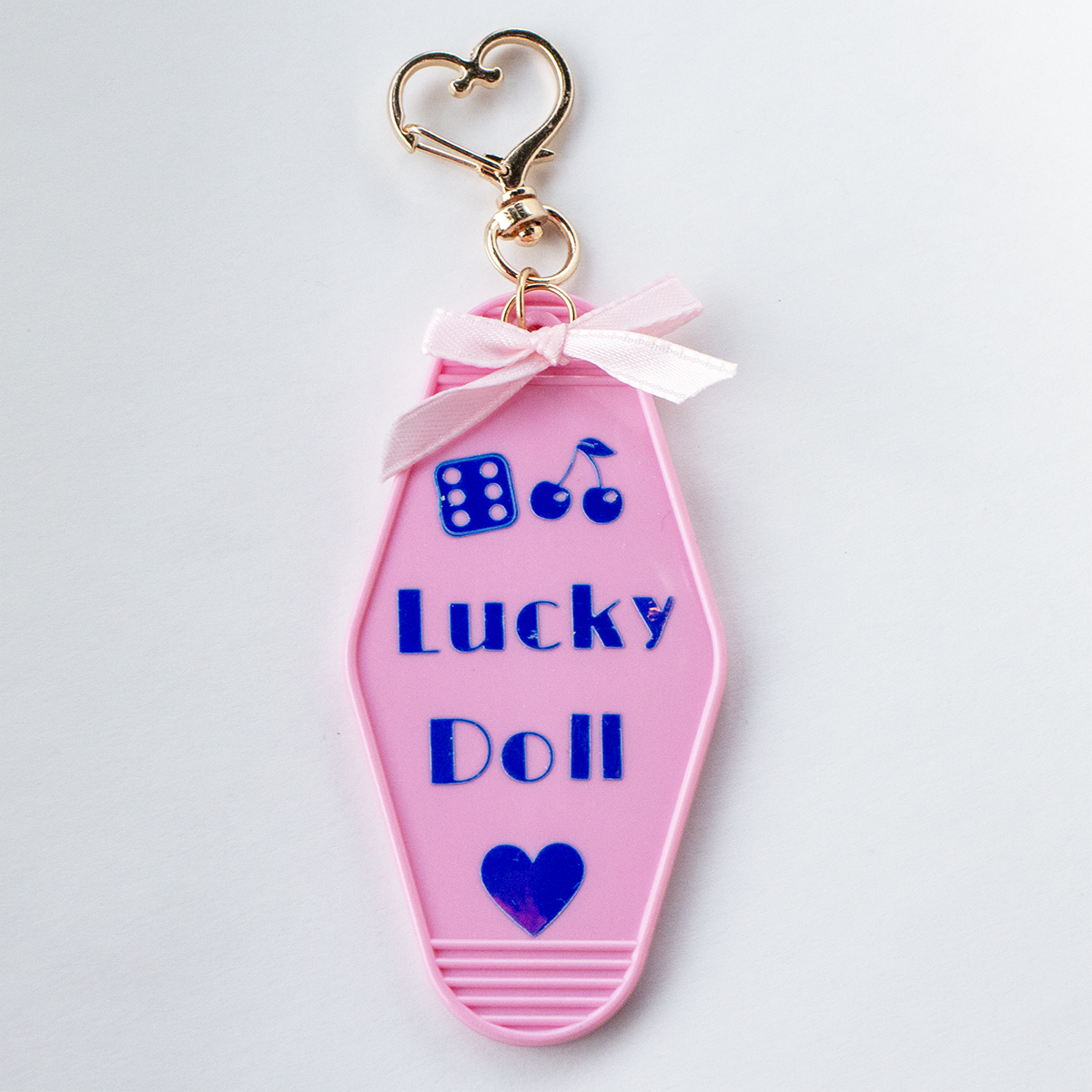 The Valley Dolls Lucky Doll pastel pink motel keychain with heart bow and gold clasp
